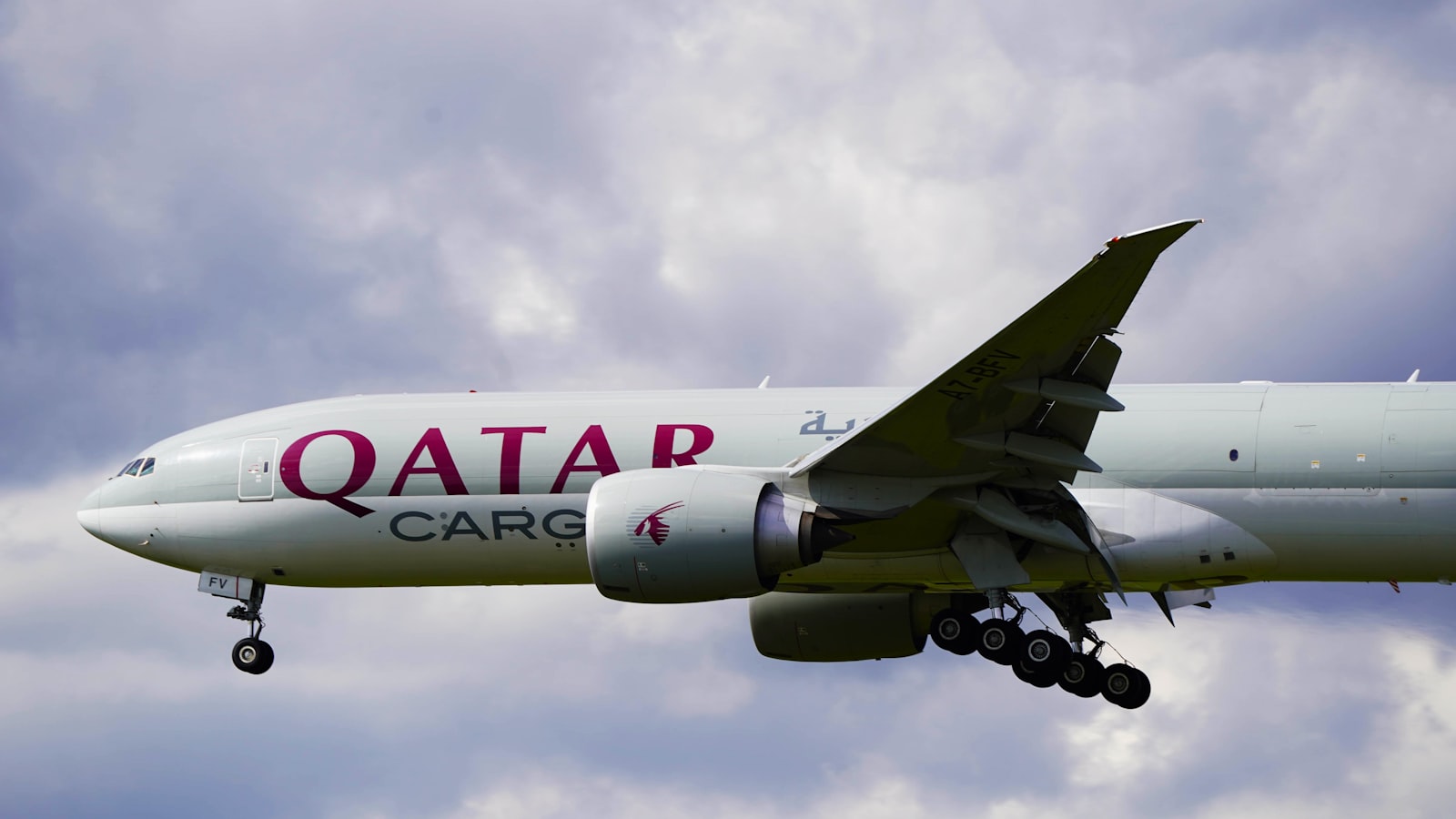 a large jetliner flying through a cloudy sky