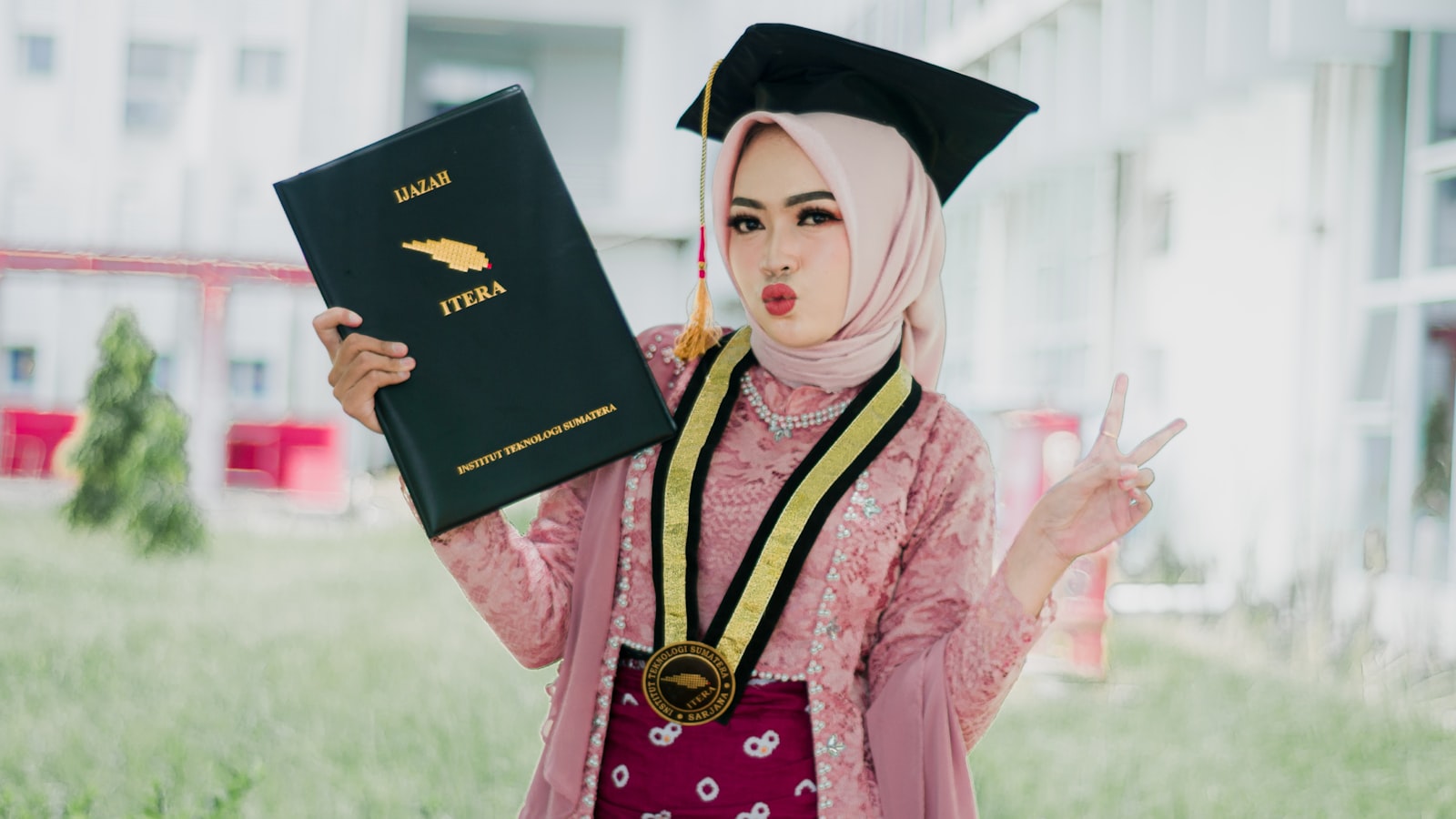 a woman in a graduation gown holding a book