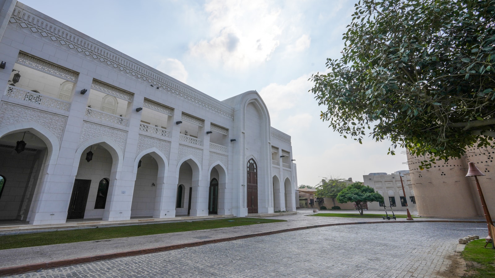 A large white building with a tree in front of it