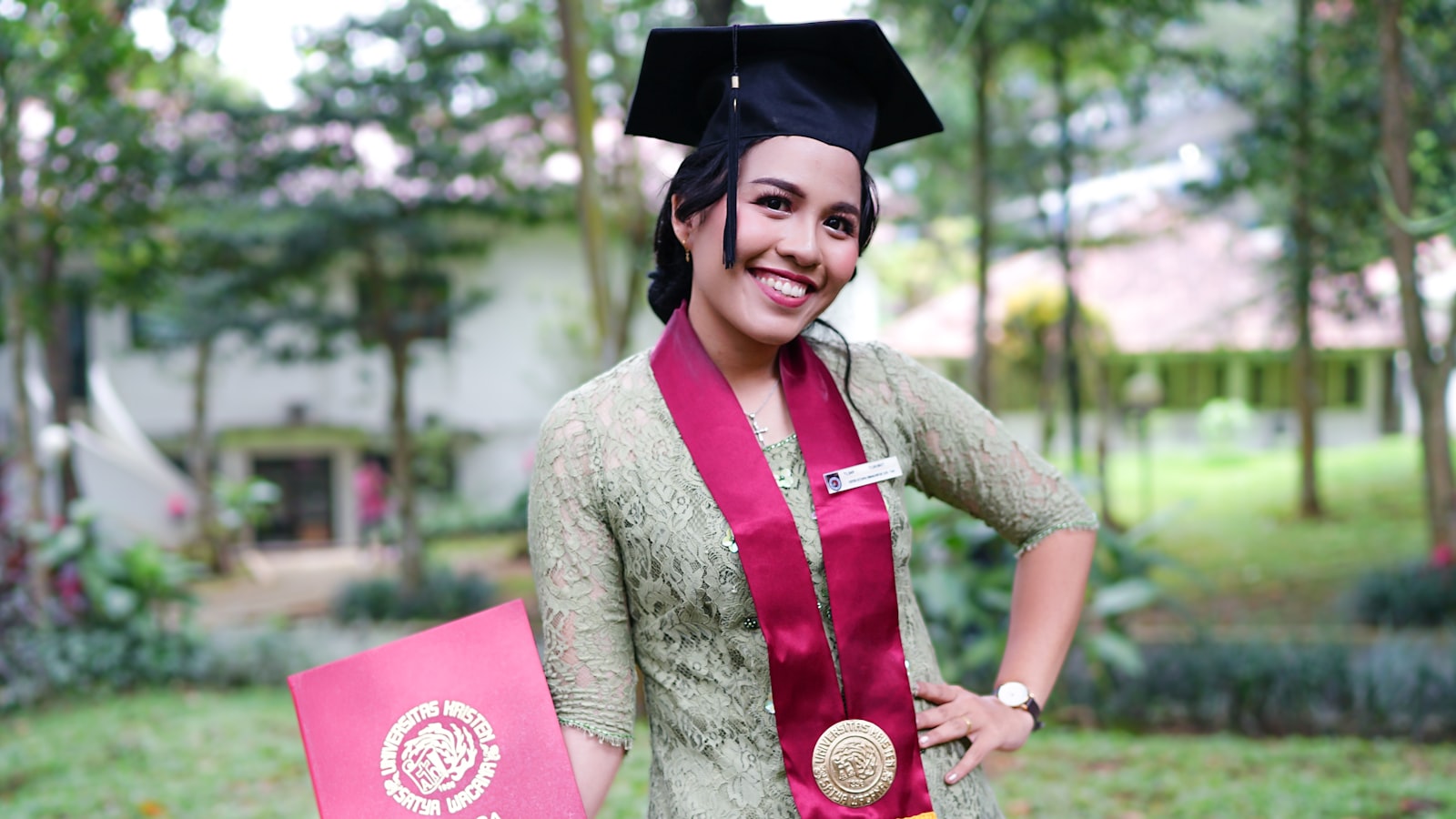 a woman in a graduation gown holding a diploma