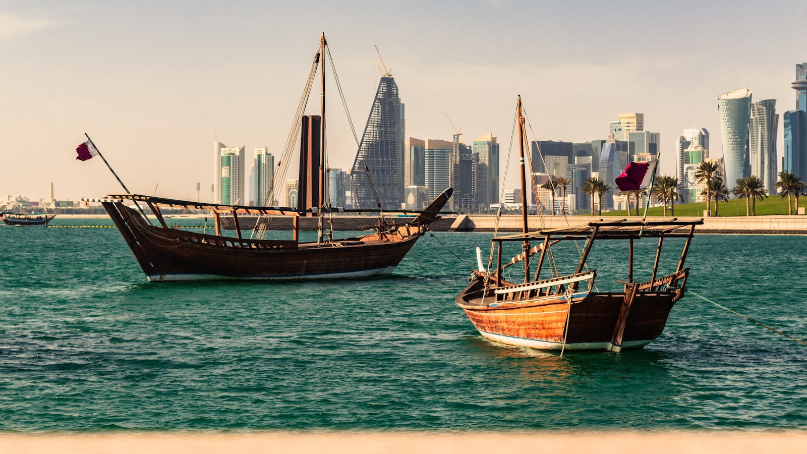 two ships on body of water near the city