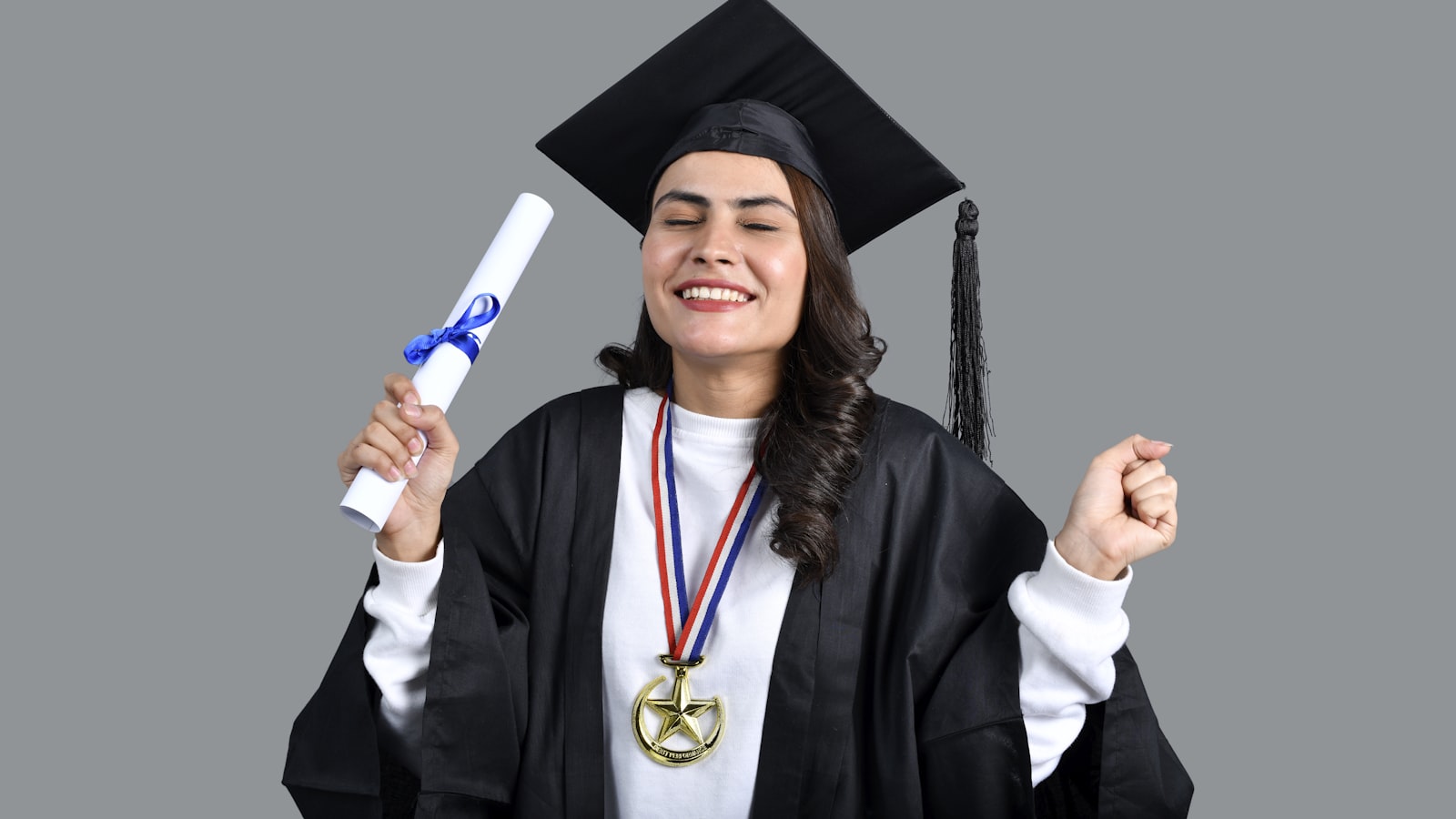 a man wearing a graduation cap and gown holding a diploma
