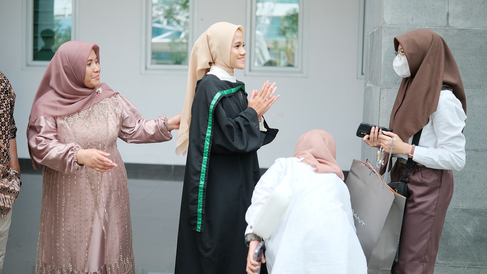 A group of people standing around each other