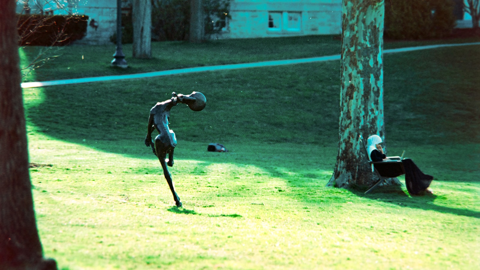 Sculpture in a grassy park with trees and trees