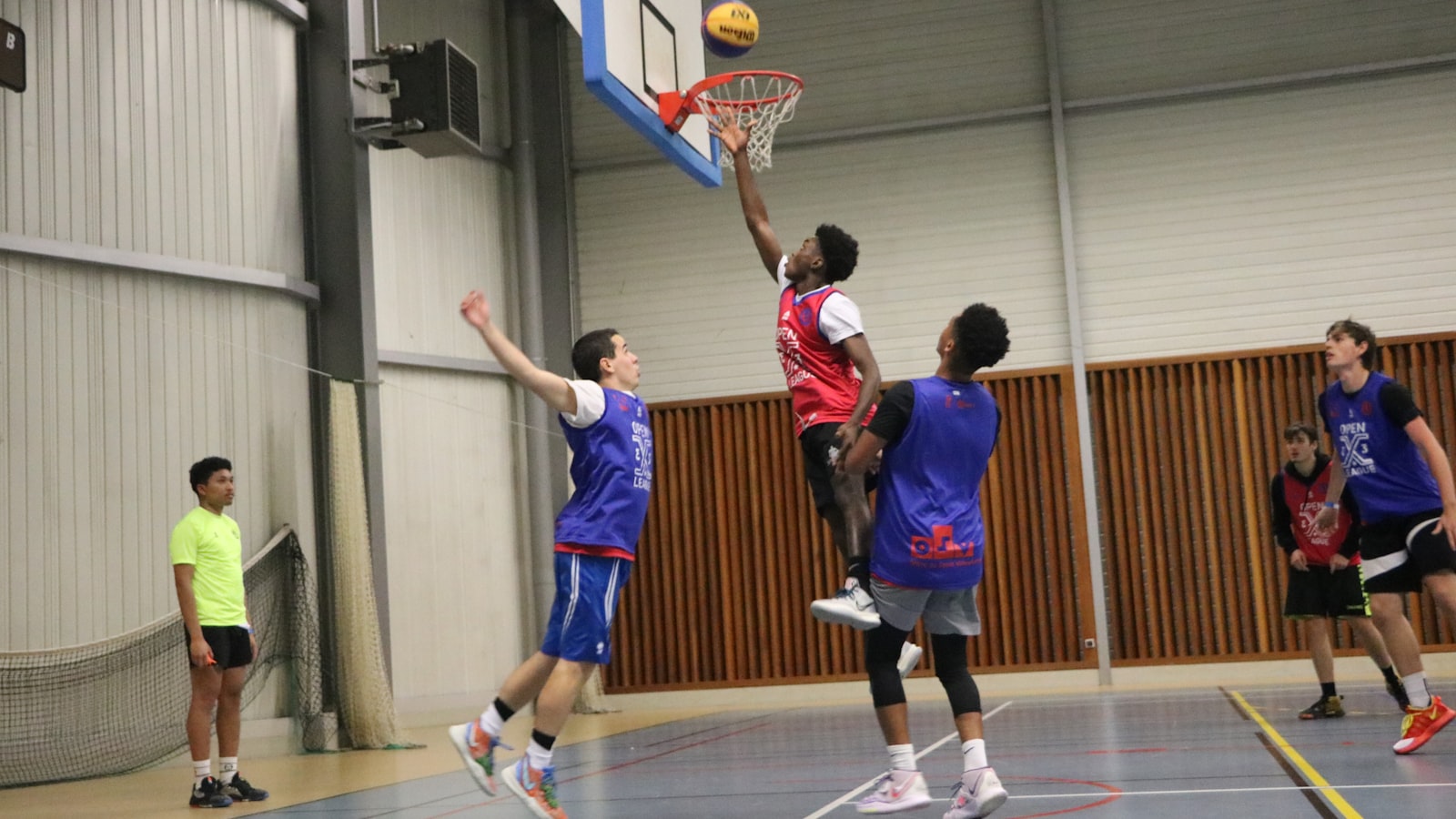 a group of young men playing a game of basketball