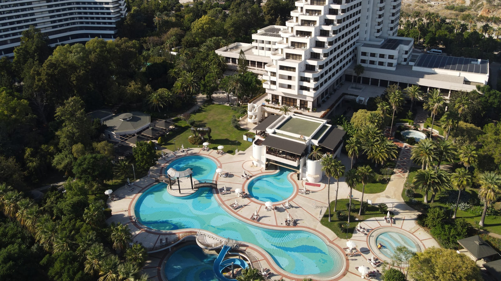 a large building with a pool in front of it
