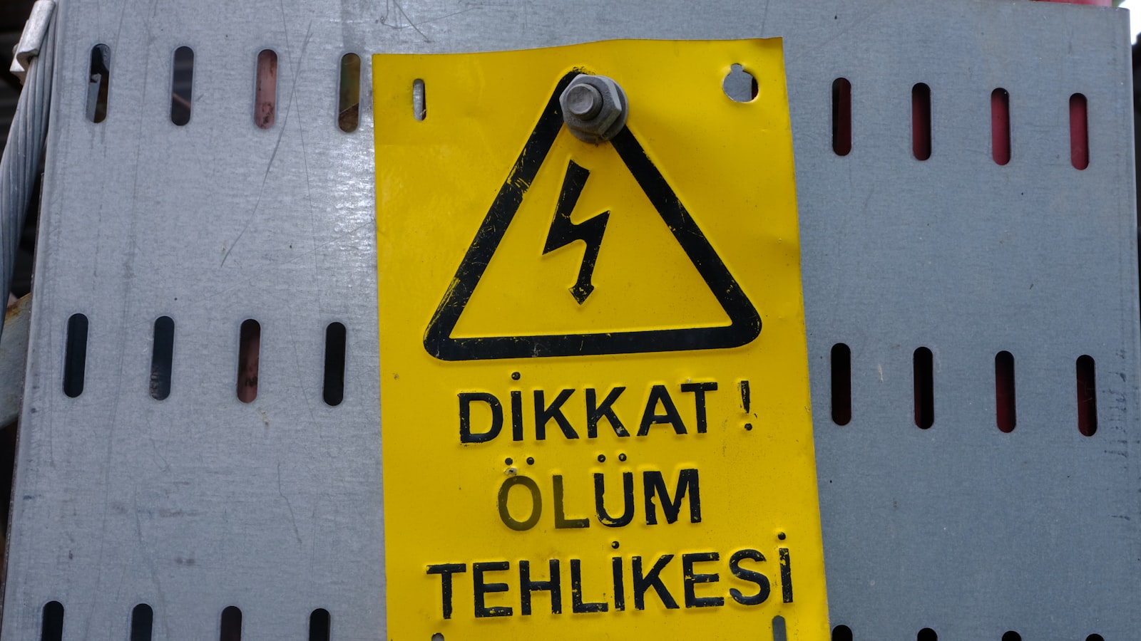 a yellow sign on a white wall