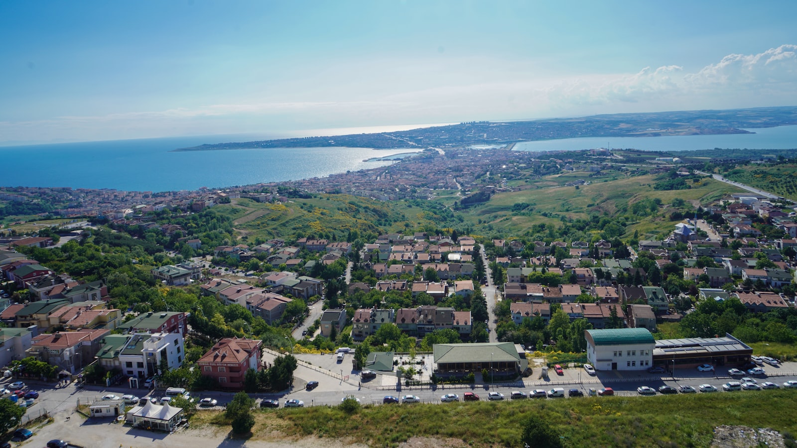 an aerial view of a city with a lake in the background