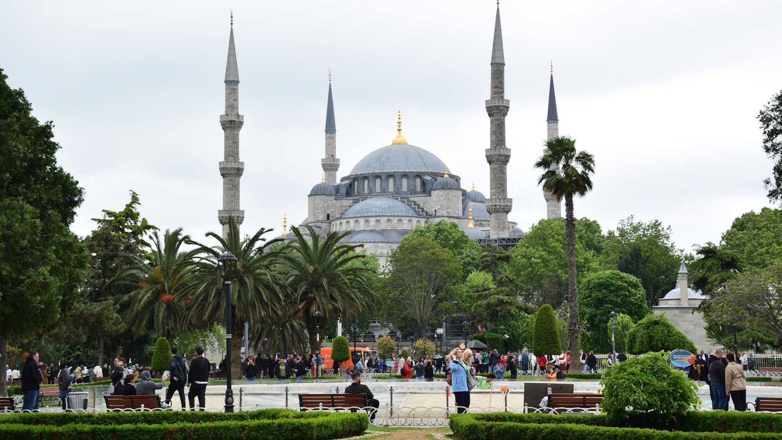 a group of people sitting on a bench in front of a building