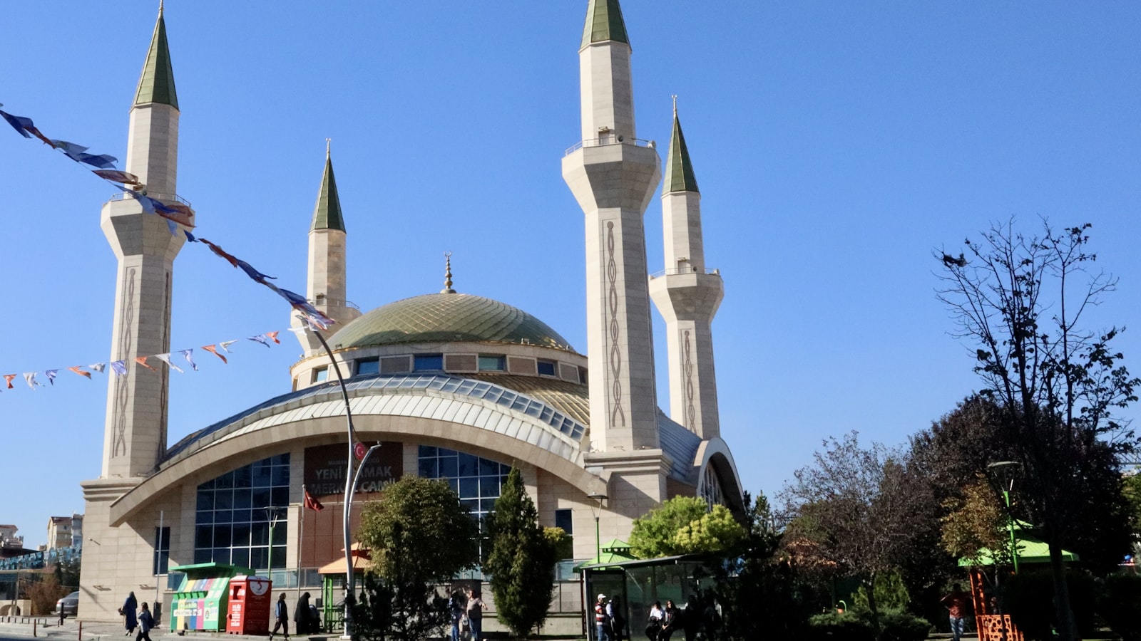 a building with a tower and kites flying in the air