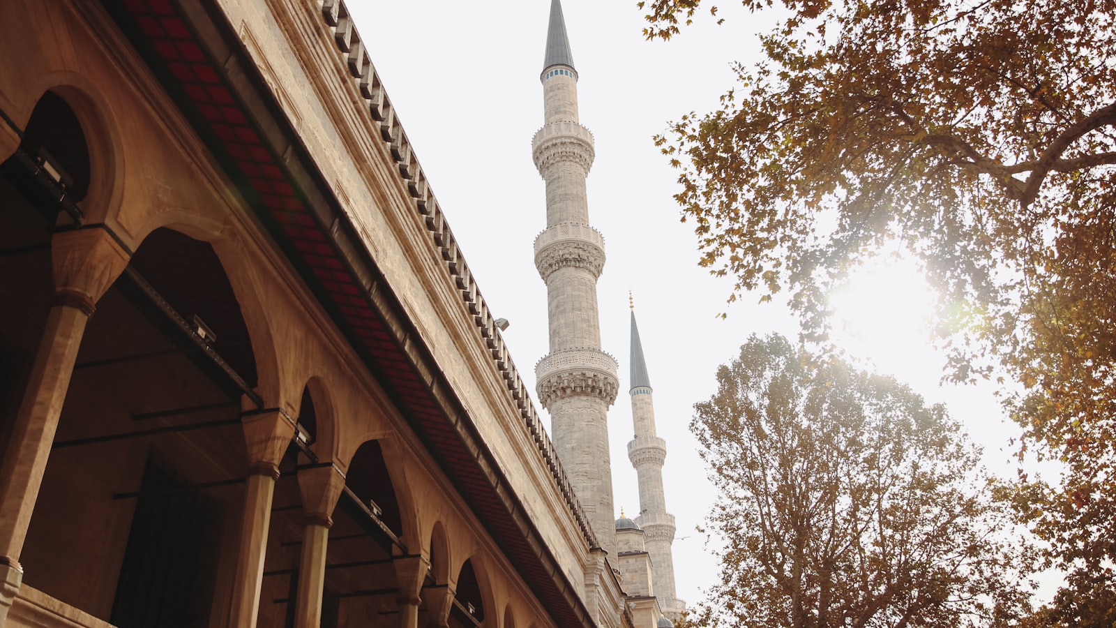 a tall white building with a clock on it's side