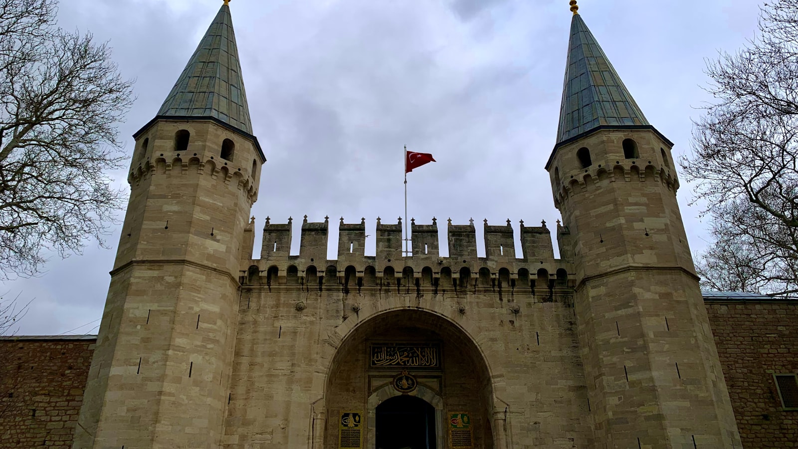a castle with two towers and a flag on top