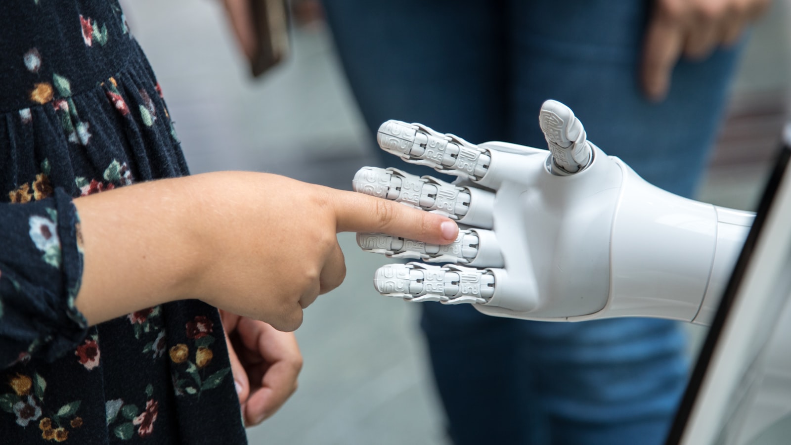 a person holding a robotic hand in front of a mirror