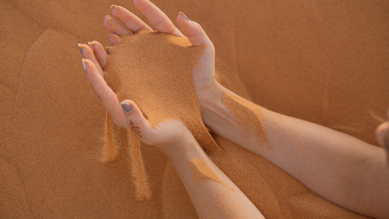persons feet on brown sand