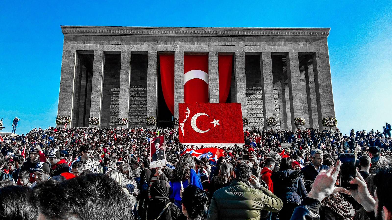 people near buildings with Turkey flag