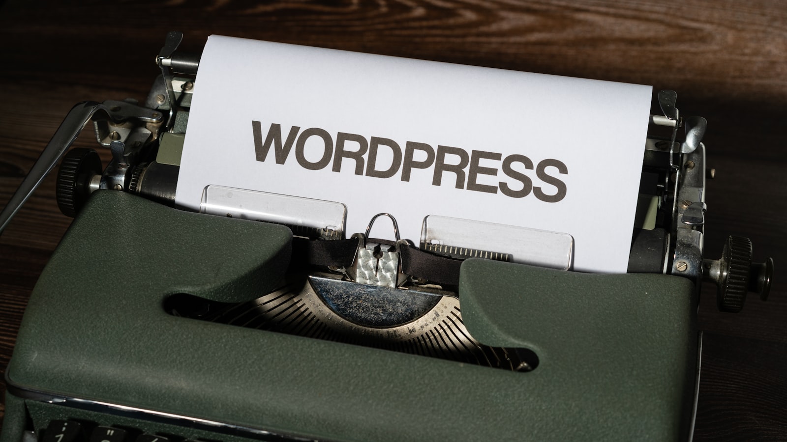a close up of a typewriter with the word wordpress printed on it