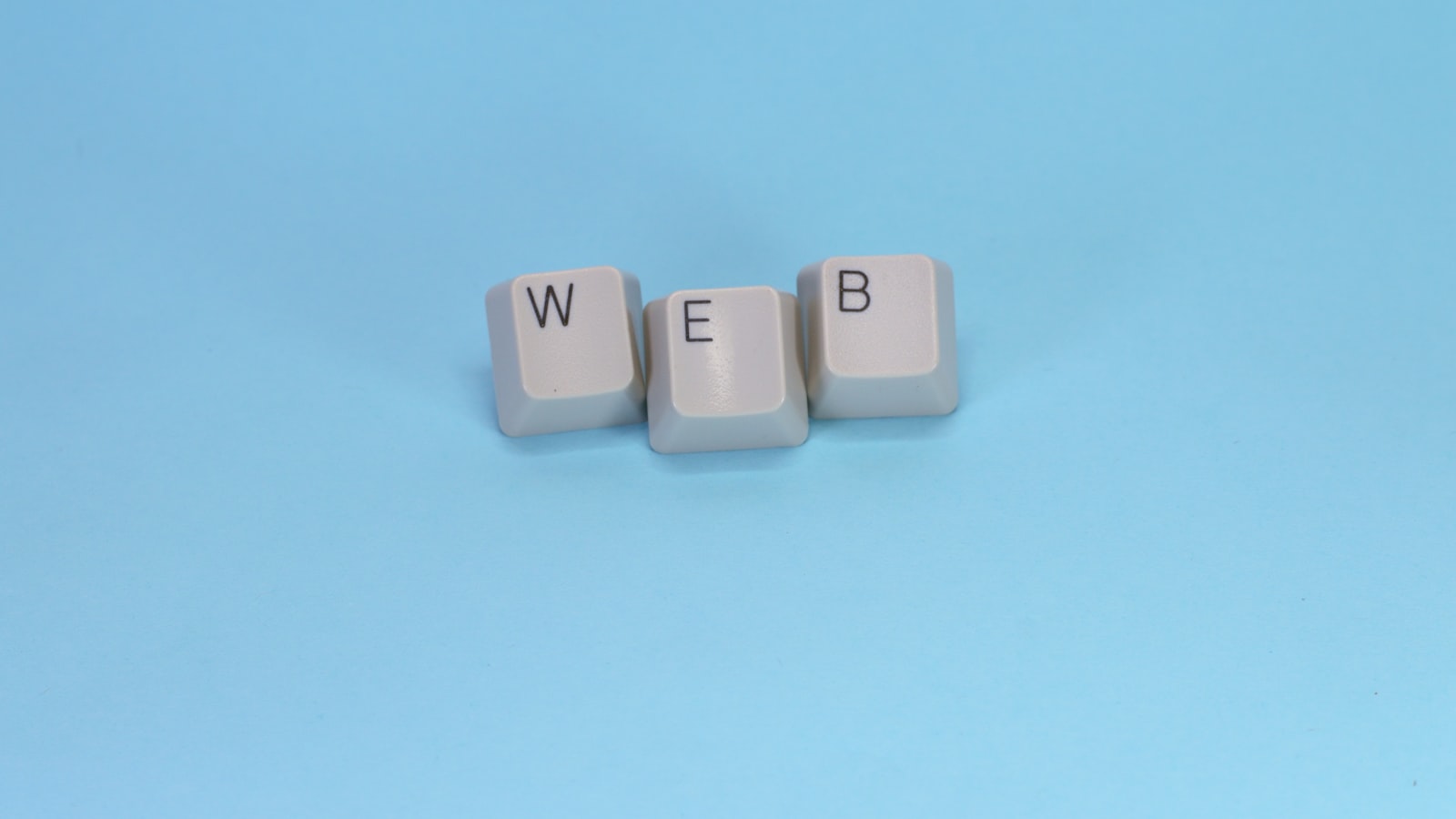 Keyboard keys spell out the word "web."