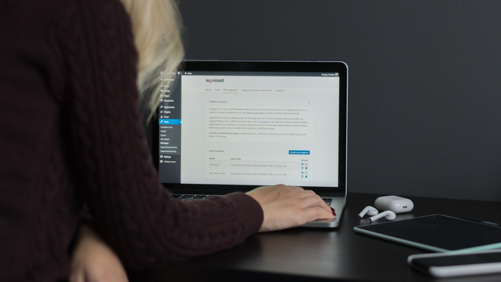 woman in black sweater using macbook pro