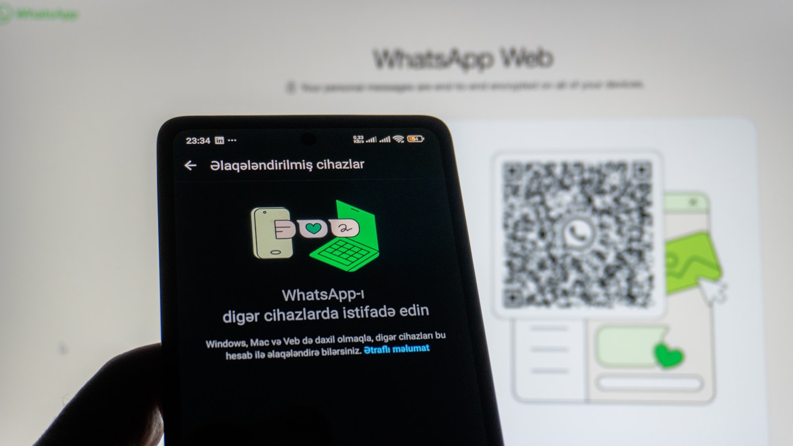 Phone scanning whatsapp web qr code on screen