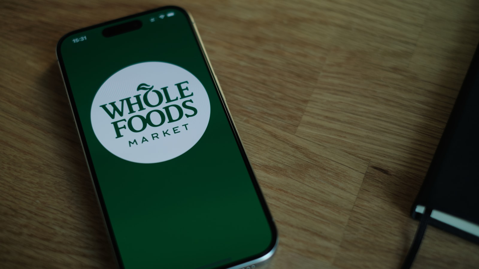 A cell phone sitting on top of a wooden table