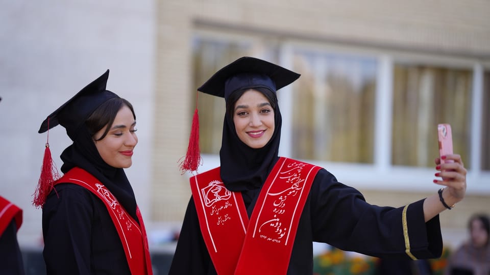 Graduates pose for a selfie at their ceremony.