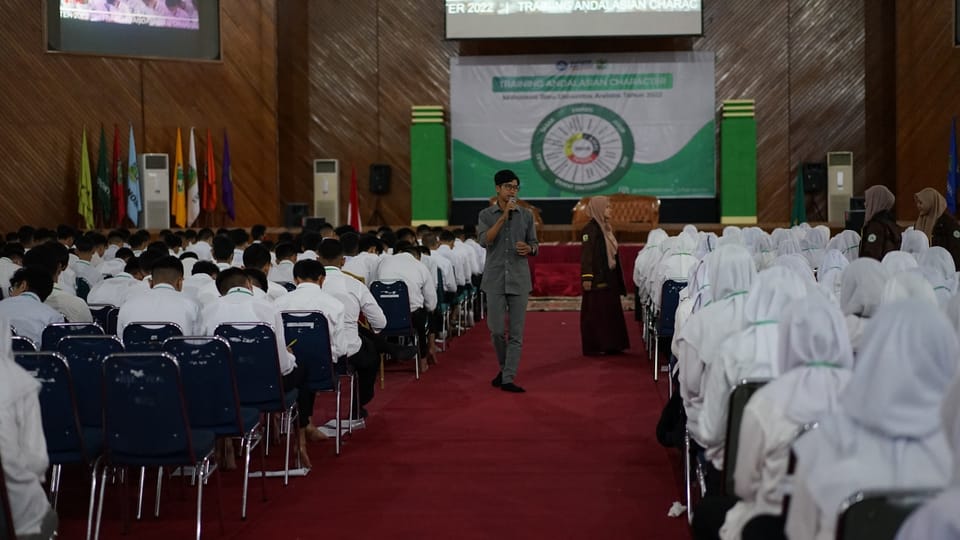 a person standing in front of a group of people in white robes