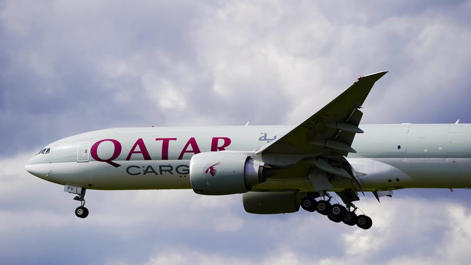 a large jetliner flying through a cloudy sky