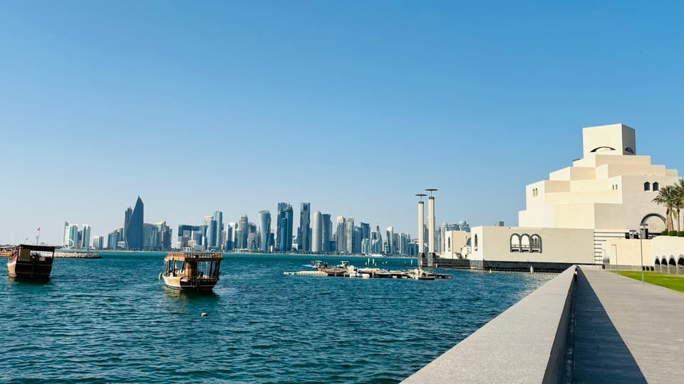 A body of water with a city in the background