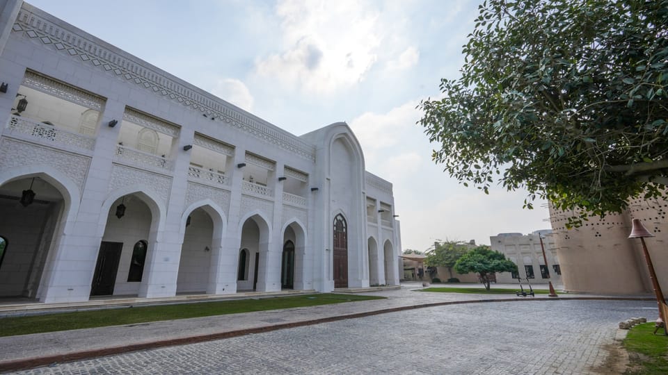 A large white building with a tree in front of it