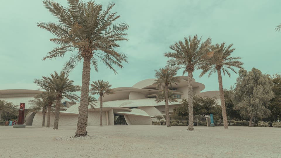 a building with palm trees in front of it