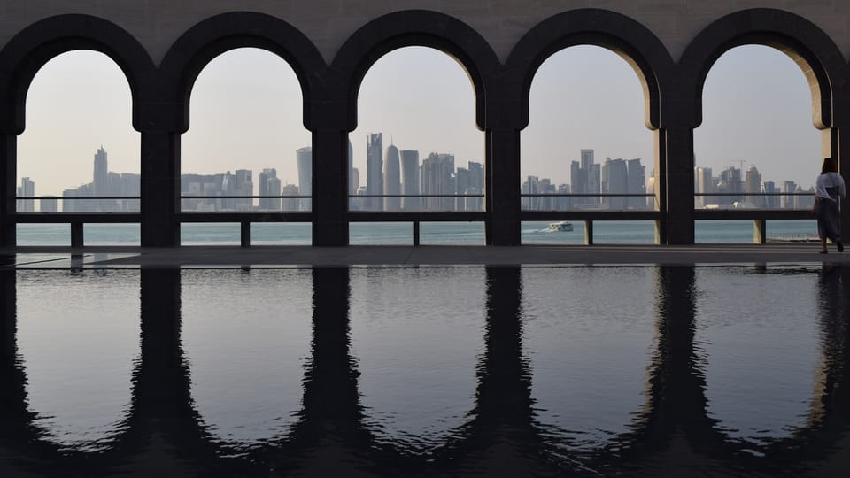 A person standing in front of a large body of water