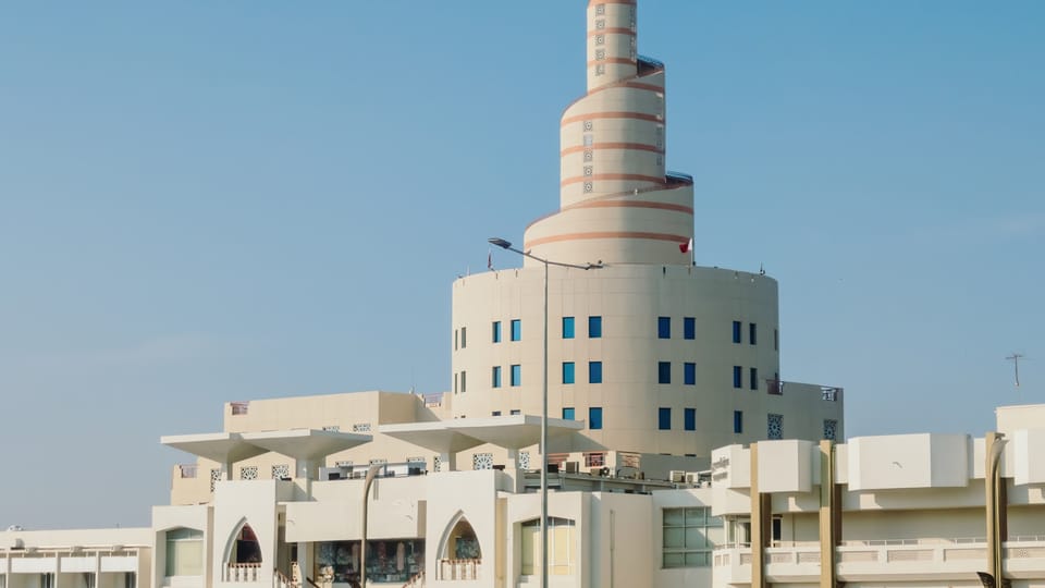 A tall white building with a clock on it's side