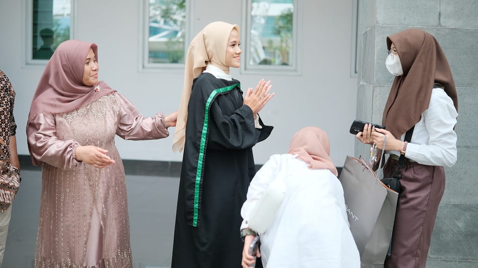 A group of people standing around each other