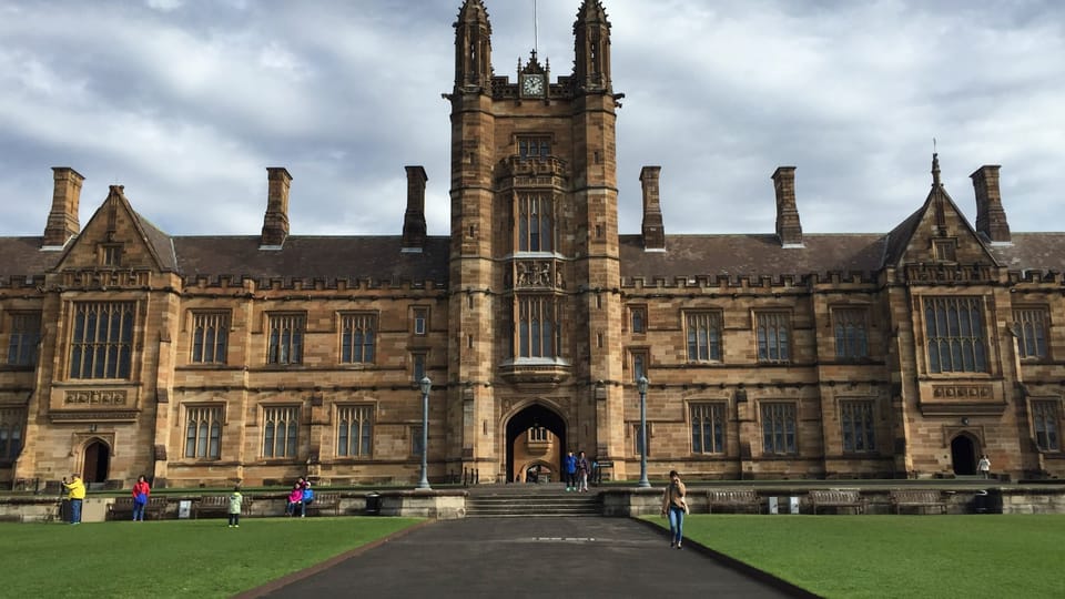 a large building with a long walkway in front of it