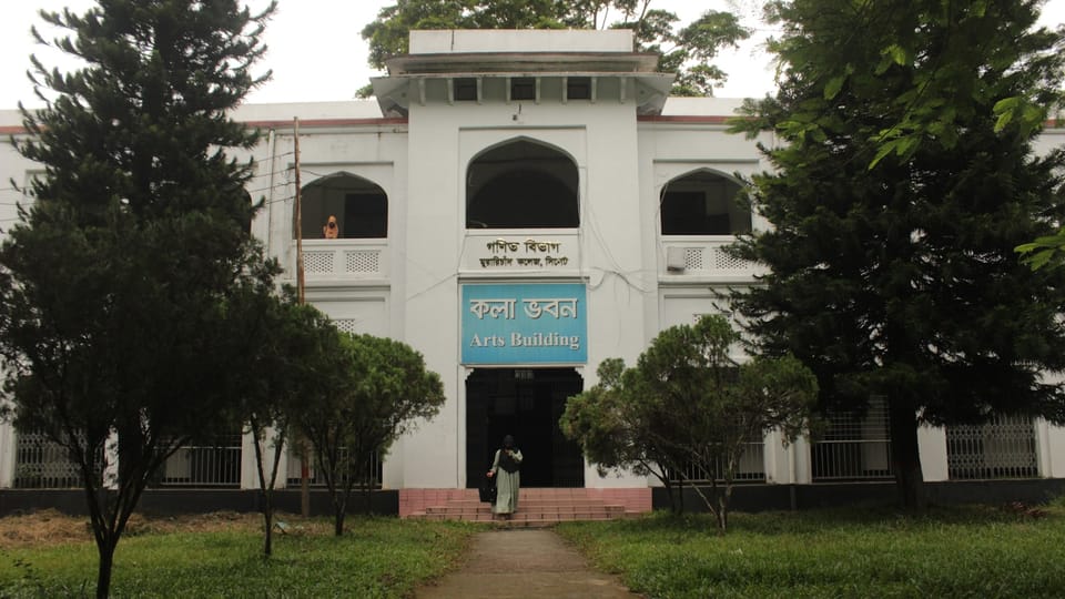 A large white building with trees in front of it