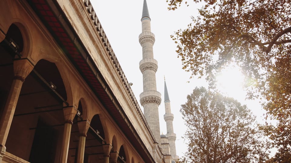 a tall white building with a clock on it's side