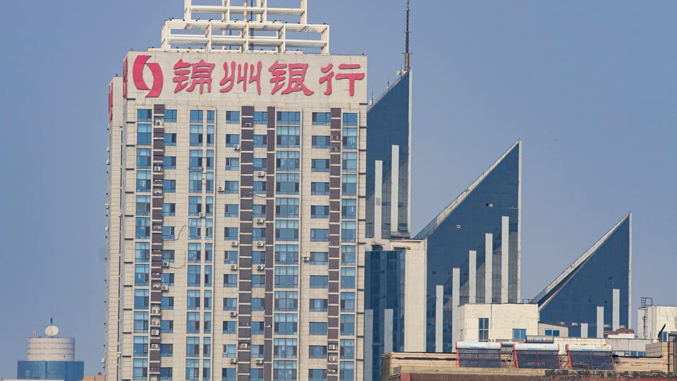 a tall building with a red and white sign in front of it