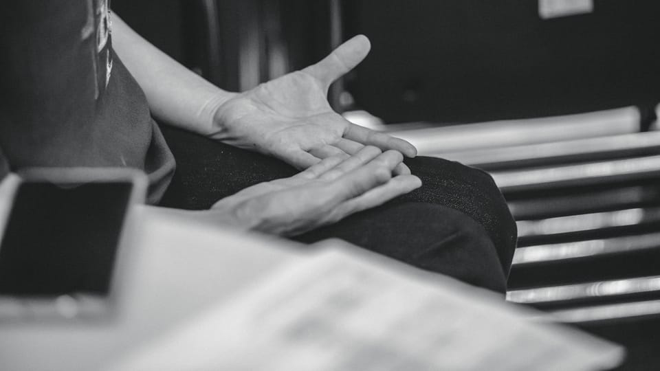 Person gesturing with hands during conversation