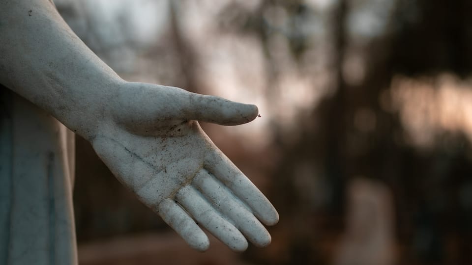 a statue of a person's hand holding something
