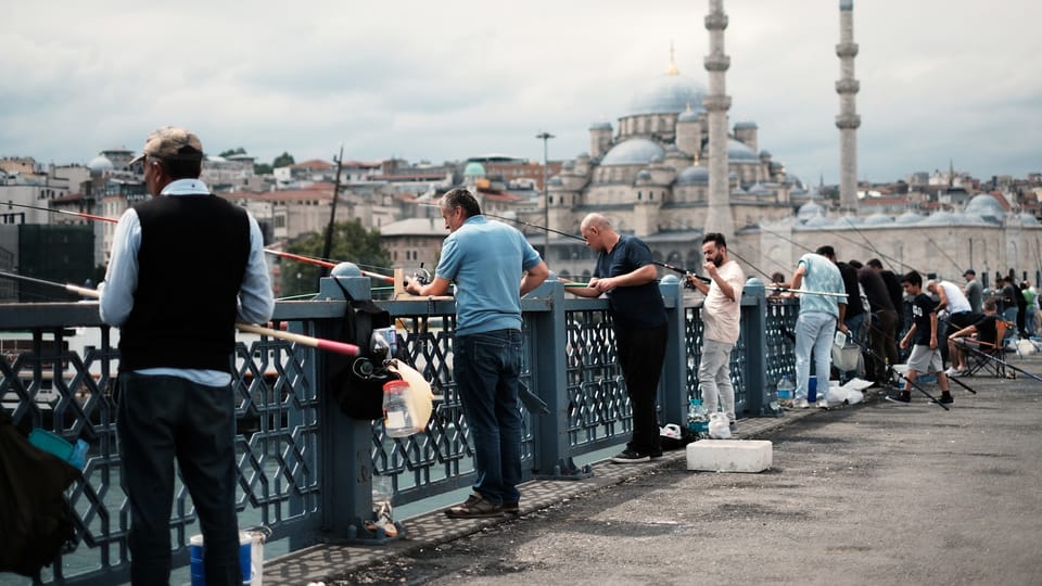 a group of people standing on top of a bridge