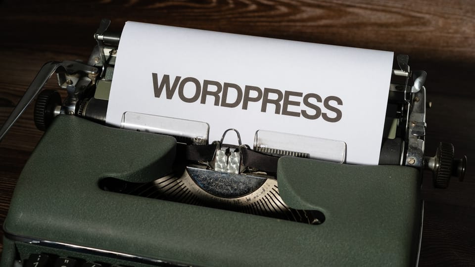a close up of a typewriter with the word wordpress printed on it