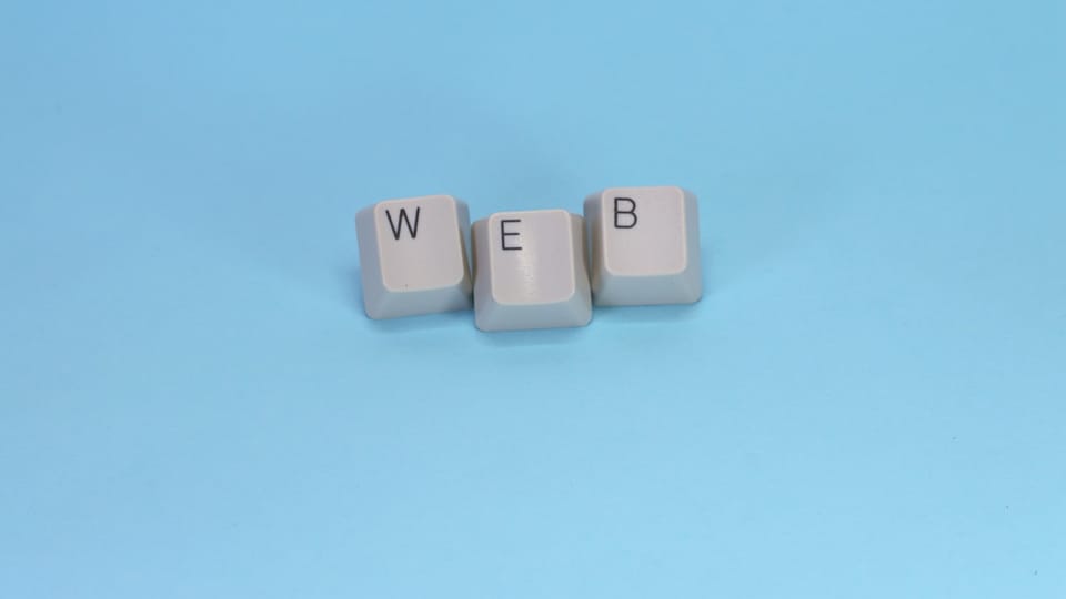 Keyboard keys spell out the word "web."