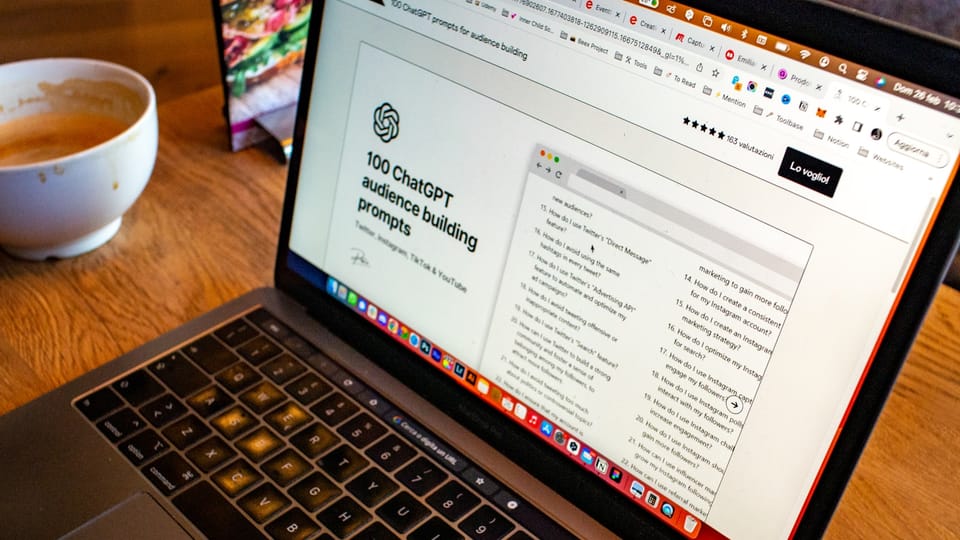 a laptop computer sitting on top of a wooden table