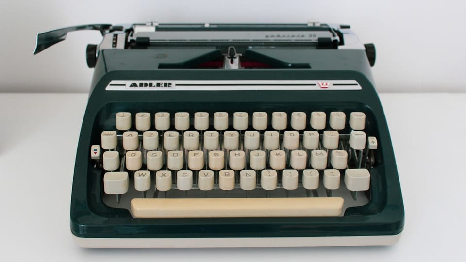 black and white typewriter on white table
