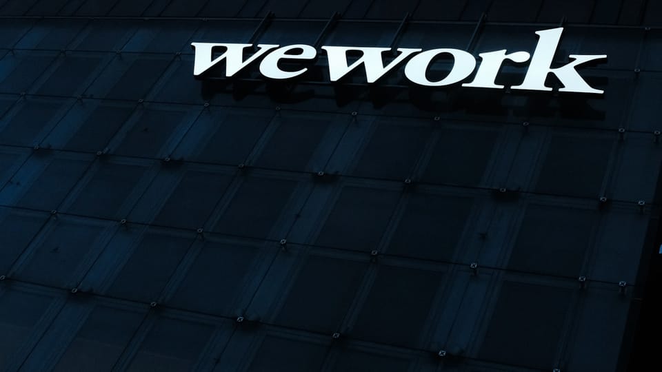 we work sign on the side of a building